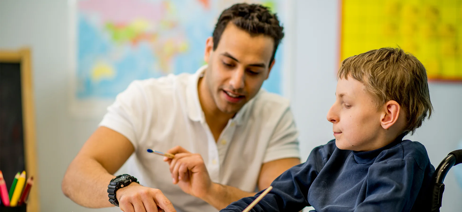 Teacher with a child in a classroom setting. The 亚洲博彩网站 ABA program provides opportunities to work with faculty in the psychology, human services and rehabilitation studies, and education departments.