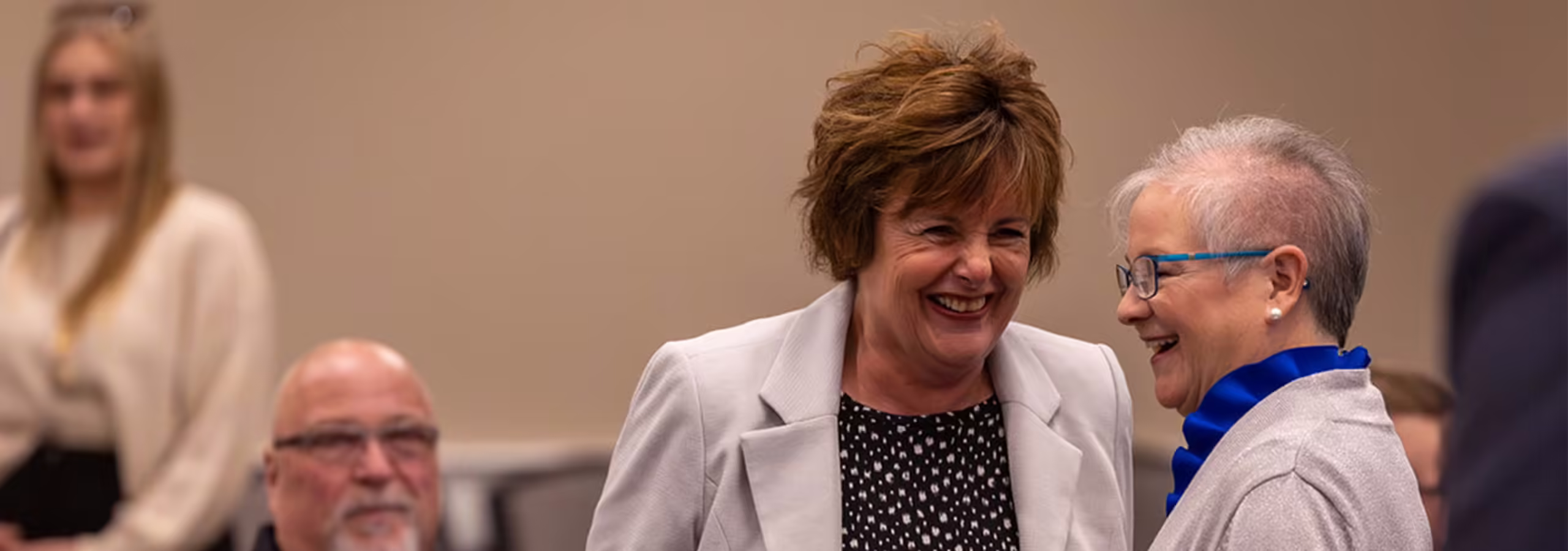 Two staff members at 亚洲博彩网站 talking to one another